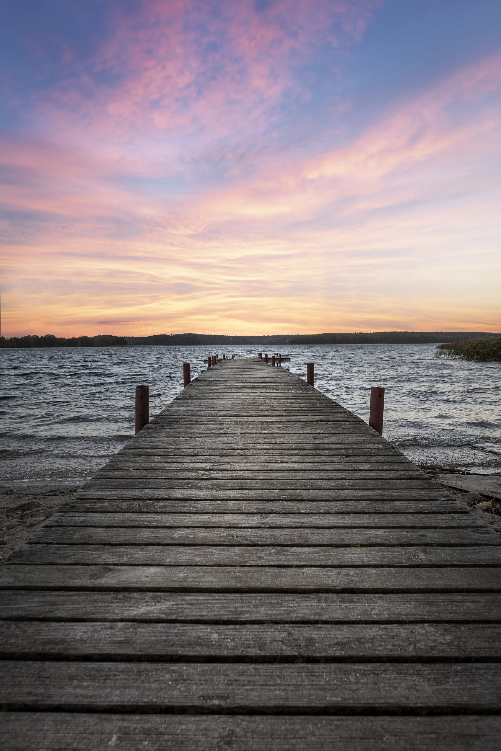 pier overlooking a calm sea at sunset